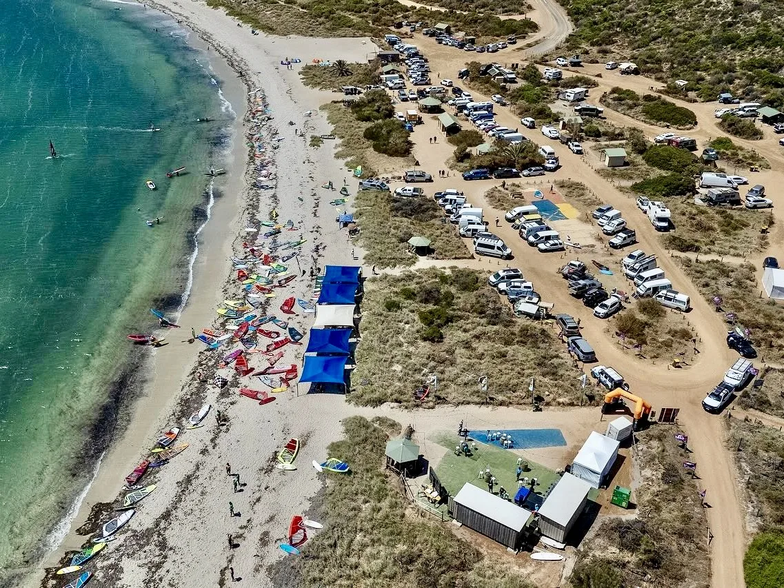 Aerial view of Wave Rally at Coronation Beach, with windsurfing equipment and the beachfront campground